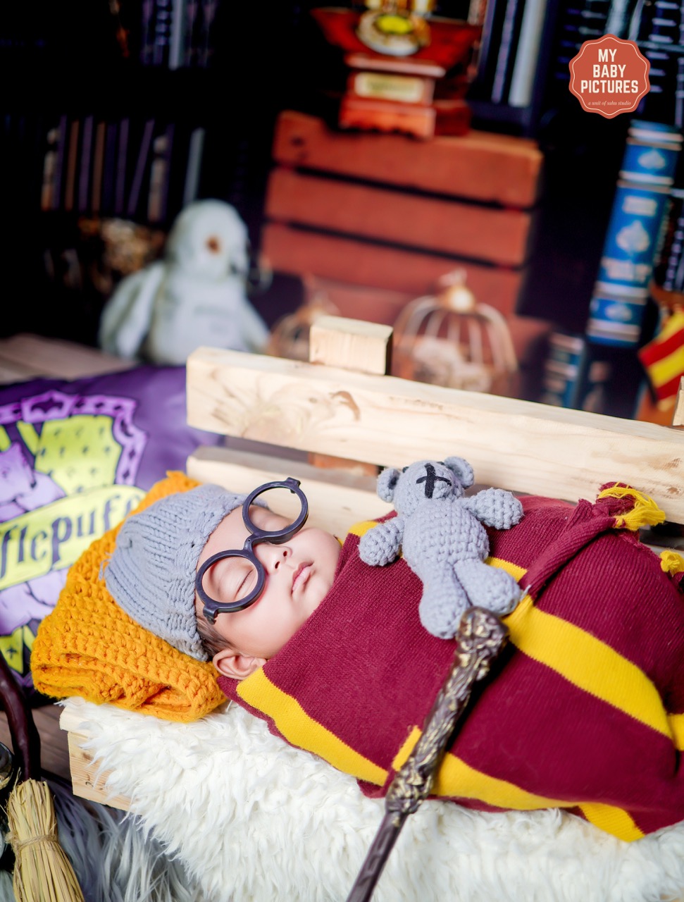 Newborn photoshoot — baby in wizard costume in Harry Potter themed setup
